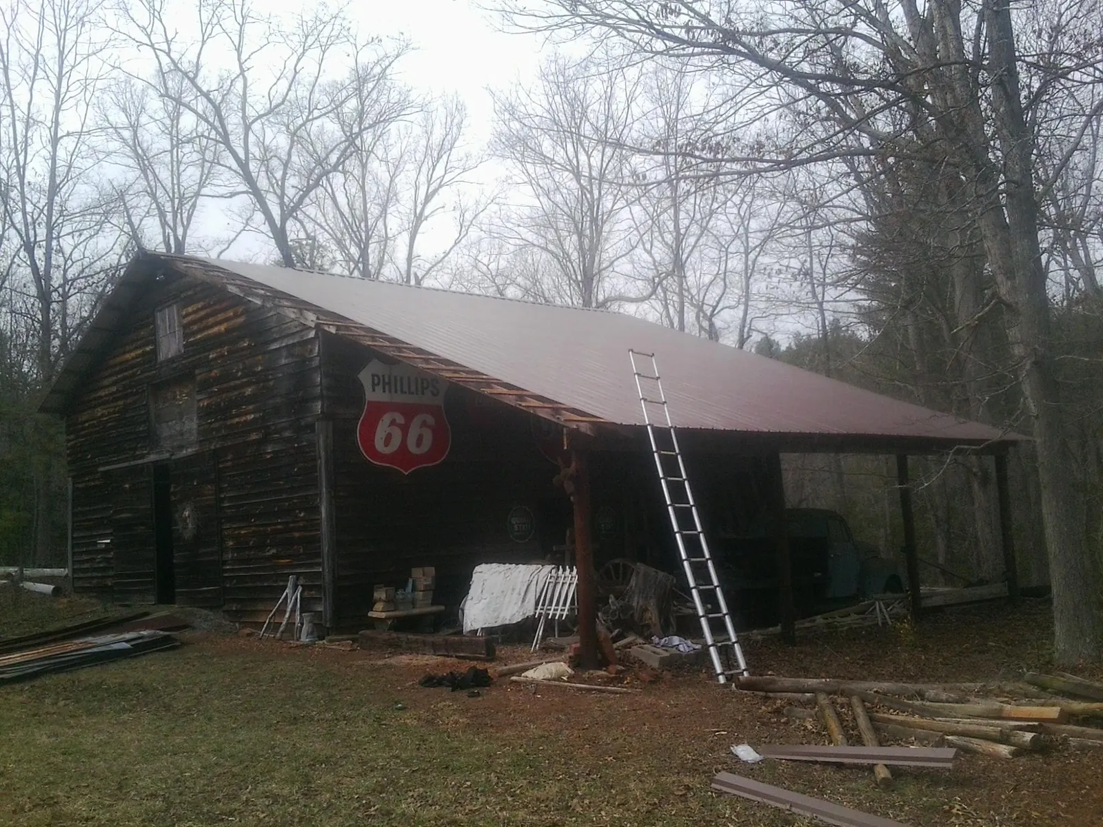 New metal roof on an open sided timber barn with a vintage sign in Perham